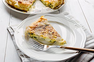 Savory pie with cheese and spinach on the plate