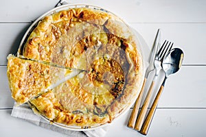 Savory pie with cheese and spinach on the plate