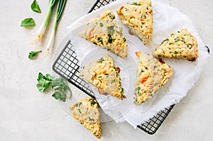 Savory scones with feta mozarella and green herbs on a wire rack