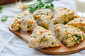 Savory scones with feta and mozarella and green herbs on a woode