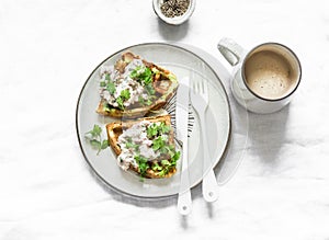 Savory zucchini waffles with tuna, cream cheese pate and coffee on a light background, top view. Delicious healthy breakfast,