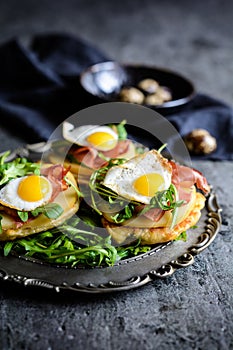 Savoury yoghurt and scallion pancakes with Black Forrest ham, smoked cheese, quail egg and arugula