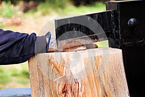 Saw cutting wood for winter. A man cutting firewood for the winter using a modern machine lumber saw.