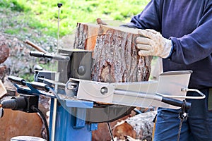 Saw cutting wood for winter. A man cutting firewood for the winter using a modern machine lumber saw.