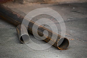 Sawed metal pipe on asphalt