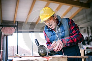 Sawing into finger with circular saw. Injured worker with wound hand. Work injury, accident in workplace.