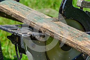 Sawing old boards with a circular saw. The process of sawing wood for processing. close the circular saw for cutting wood