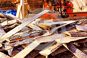 After sawing, wood scrap debris is stacked near a sawmill