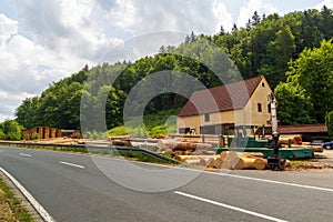 Sawmill and logs at river Trubach near Obertrubach (Franconian Switzerland), Bavaria, Germany