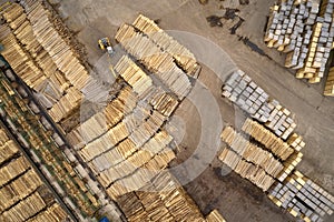 Sawmill logs stacked aerial view and wood saw machinery