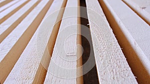 Sawn boards lie on the floor parallel to each other for drying. Preparation for the installation of an eco-friendly wooden floor i