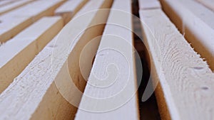 Sawn boards lie on the floor parallel to each other for drying. Preparation for the installation of an eco-friendly wooden floor i