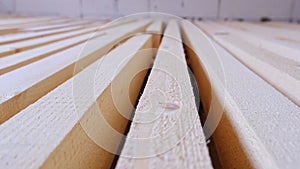 Sawn boards lie on the floor parallel to each other for drying. Preparation for the installation of an eco-friendly wooden floor i