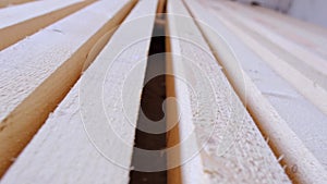 Sawn boards lie on the floor parallel to each other for drying. Preparation for the installation of an eco-friendly wooden floor i