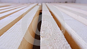 Sawn boards lie on the floor parallel to each other for drying. Preparation for the installation of an eco-friendly wooden floor i