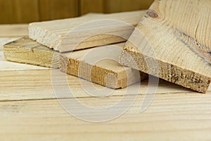 Sawn boards lie on the wooden surface.Construction materials from pine