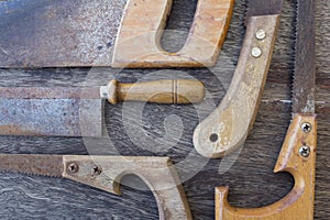 Saws / old handsaws details on wooden background