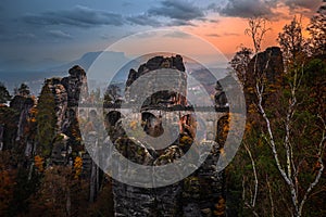 Saxon, Germany - The Bastei bridge with a sunny autumn sunset with colorful foliage in Saxon Switzerland National Park