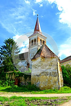 Saxon medieval lutheran church . Typical rural landscape and peasant houses in the village Beia, Transylvania, Romania.