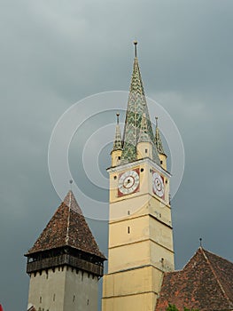 Saxon tower clock closeup in Medias, Romania, on dark sky and cl
