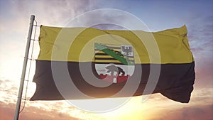 Saxony-Anhalt flag, Germany, waving in the wind, sky and sun background. 3d rendering