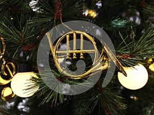 Saxophone and light on Christmas tree decoration, season greeting.