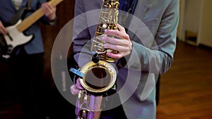 Saxophone, music instrument played by saxophonist player musician in wedding party.