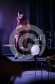 Saxophone player in glases performing on stage