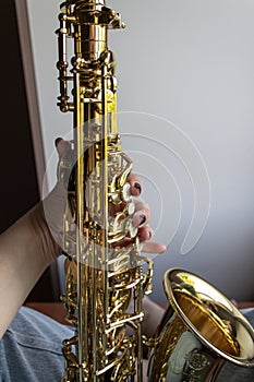 Saxophone Player hands Saxophonist playing jazz music. Alto sax musical instrument closeup