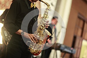 The saxophone player plays his instrument at a wedding party