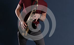 Saxophone Player Saxophonist playing jazz music. Sax alto Musician hands closeup
