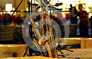 Saxophones leaning against microphone