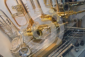 Saxophones and trumpet on the showcase of a music store