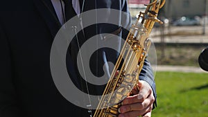 Saxophonist in dinner jacket play on golden saxophone. Live performance. a man playing saxophone jazz music.