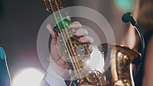 Saxophonist in dinner jacket play on golden saxophone. Performance. Jazz artist