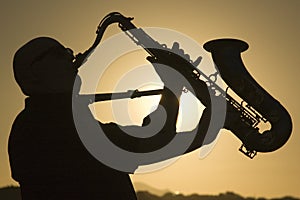 Saxophonist at dusk 2 photo