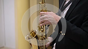 Saxophonist musician playing saxophone or sax at the concert or party