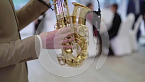 Saxophonist musician playing saxophone or sax at the concert or party