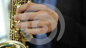 Saxophonist musician playing saxophone or sax at party. selective focus