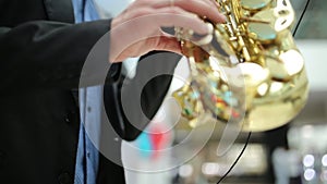 Saxophonist musician playing saxophone or sax at party. selective focus