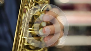 Saxophonist musician playing saxophone or sax at party. selective focus