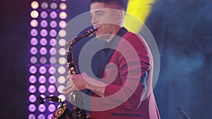 Saxophonist play on golden saxophone. Live performance. Jazz music