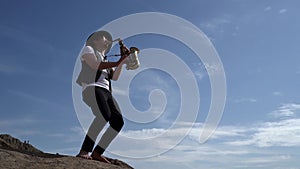 Saxophonist is playing melody, standing against blue sky, music and nature