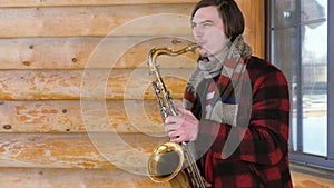 Saxophonist plays the saxophone, in winter