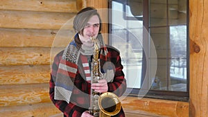 Saxophonist plays the saxophone, in winter