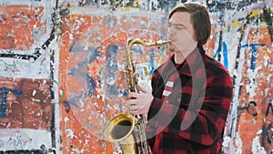 Saxophonist plays the saxophone, in winter