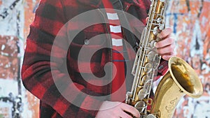 Saxophonist plays the saxophone, in winter