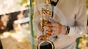 Saxophonist in white shirt play on golden saxophone. Live performance. Jazz music.