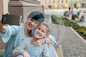 Say cheese. mother and daughter taking selfie with cellphone