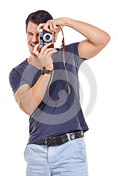 Say cheese. Studio portrait of a handsome young man holding a retro camera isolated on white.